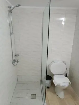 a bathroom with a toilet and a glass shower stall at Imeros in Chania Town