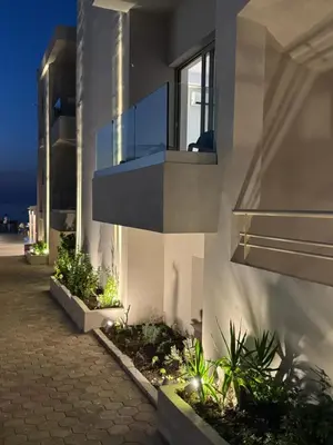 a building with a balcony on the side of it at Τhe Noverian Antama Organic Beach Resort Chania with Outdoor Heated Pool in Agia Marina Nea Kydonias