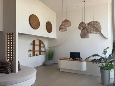 a living room with a desk and pendant lights at Τhe Noverian Antama Organic Beach Resort Chania with Outdoor Heated Pool in Agia Marina Nea Kydonias