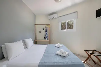 a bedroom with a bed with two towels on it at Villa Life in Agia Marina Nea Kydonias