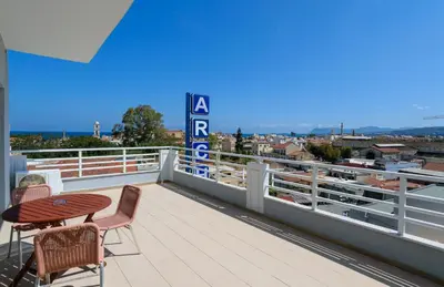 a patio with a table and chairs on a balcony at Archontiki City Hotel in Chania Town