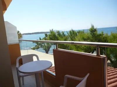 a balcony with a table and a table and a view of the water at Melani Apartments in Chania Town