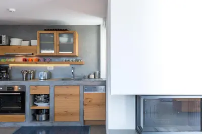 a kitchen with wooden cabinets and a counter top at Elea Villas - Aspro & Blanche in Almirida
