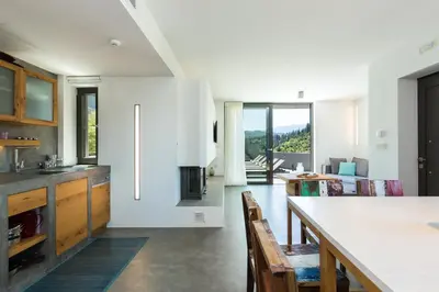 a kitchen and dining room with a table and chairs at Elea Villas - Aspro & Blanche in Almirida