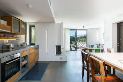 a kitchen with a table and a dining room at Elea Villas - Aspro & Blanche in Almirida