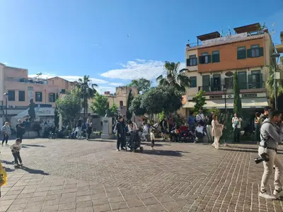 a group of people walking around in a street at Nikolas Rooms in Chania Town