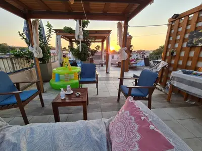 a patio with a couch and chairs and a table at Nikolas Rooms in Chania Town