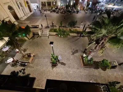 an overhead view of a courtyard in a building with palm trees at Nikolas Rooms in Chania Town