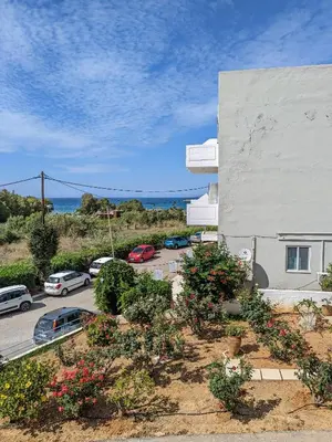 a view of a parking lot next to a building at Kalliopi Studios - Apartments in Kato Daratso