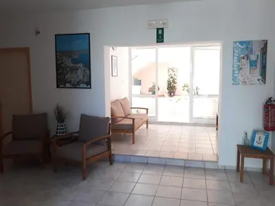 a living room with two chairs and a couch at Kalliopi Studios - Apartments in Kato Daratso