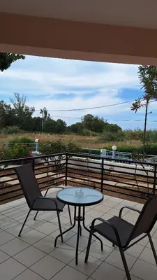 a patio with two chairs and a table on a balcony at Kalliopi Studios - Apartments in Kato Daratso
