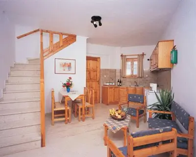 a kitchen and dining room with a table and chairs at Villa Alexander in Kalathas