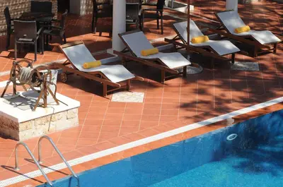 a group of chairs sitting next to a swimming pool at Metohi Georgila in Maleme