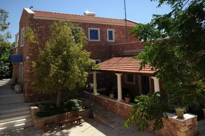 a brick house with a tree in front of it at Metohi Georgila in Maleme