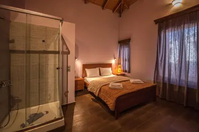 a bedroom with a bed and a glass shower at PRIVATE Sapphiros Villa in Kissamos