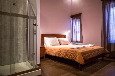 a bedroom with a bed and a glass shower at PRIVATE Sapphiros Villa in Kissamos