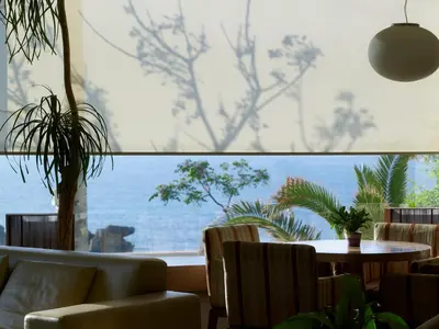 a room with a table and chairs and a large window at Irida Hotel in Chania Town