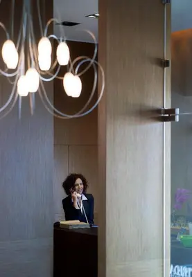 a woman talking on a microphone in a room at Irida Hotel in Chania Town