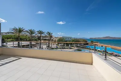 a view of the ocean from the balcony of a resort at Cretan Dream Resort & Spa in Stalos
