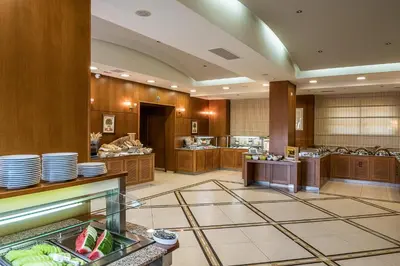 a restaurant with plates on the counter in a room at Cretan Dream Resort & Spa in Stalos