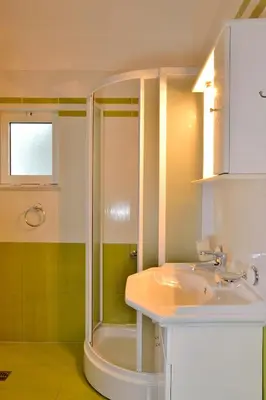 a bathroom with a shower and a sink at Elia Kounoupidiana Apartment in Kounoupidhianá