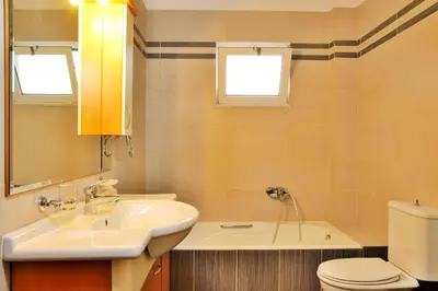 a bathroom with a sink and a toilet at Elia Kounoupidiana Apartment in Kounoupidhianá
