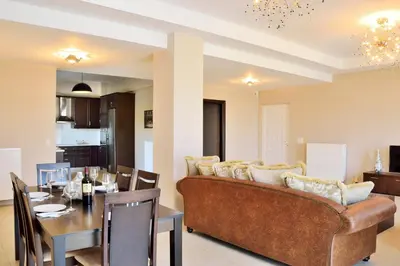 a living room and dining room with a couch and a table at Elia Kounoupidiana Apartment in Kounoupidhianá