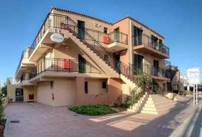 a building with stairs on the side of it at Margarita Beach Hotel in Agia Marina Nea Kydonias