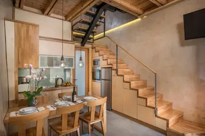 a kitchen and dining room with a staircase in a house at Neoria Houses in Chania Town