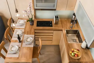 a small kitchen with a table and a sink at Neoria Houses in Chania Town