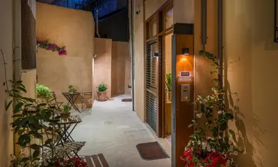 an empty hallway with plants on the side of a building at Neoria Houses in Chania Town