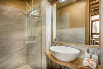 a bathroom with a sink and a glass shower at Neoria Houses in Chania Town