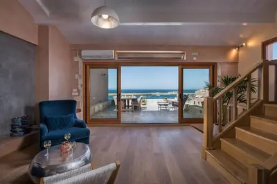 a living room with a view of the ocean at Residenza Vranas Boutique Hotel in Chania Town