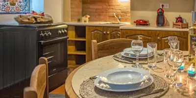 a kitchen with a table with plates and glasses on it at Casa Sabbionara in Chania Town