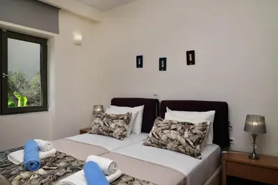 a bedroom with two beds and a window at Sunlight Breeze Villa in Chania Town