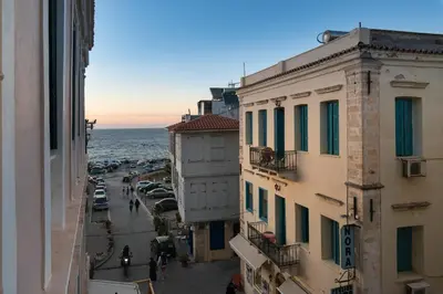 a view of a city street with cars and the ocean at Aeria Apartments in Chania Town