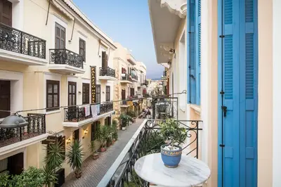 a balcony with a table and potted plants at Aeria Apartments in Chania Town