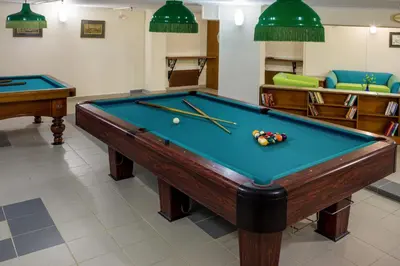 a billiard room with a pool table and two cues at Chrispy Beach Resort, Agia Marina in Agia Marina Nea Kydonias