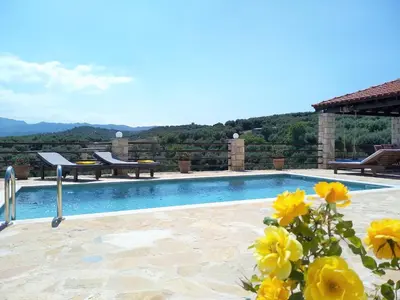 a villa with a swimming pool with yellow flowers at Little House on the Prairie - Chania in Katokhórion