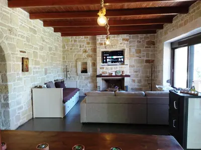 a living room with a couch and a fireplace at Little House on the Prairie - Chania in Katokhórion