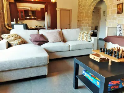 a living room with two couches and a chess board on a table at Little House on the Prairie - Chania in Katokhórion