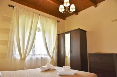 a bedroom with towels on a bed with a window at Little House on the Prairie - Chania in Katokhórion