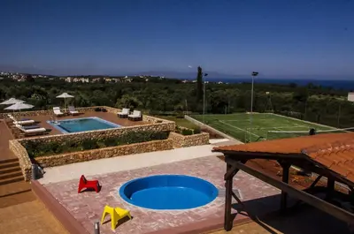 a backyard with a swimming pool and a tennis court at Horizon Villa Kampani in Kambánion