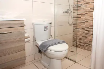 a bathroom with a toilet with a towel on it at Argo Rooms-Papadakis in Kissamos