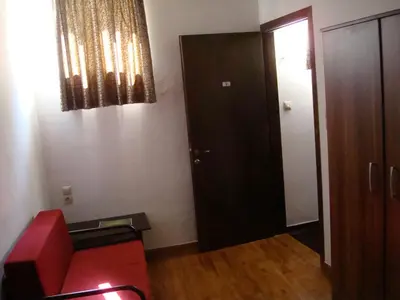 a living room with a red couch and a door at Old Town Apartments in Chania Town