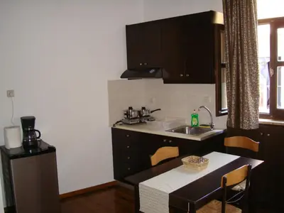 a small kitchen with a sink and a table at Old Town Apartments in Chania Town