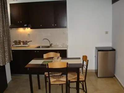 a kitchen with a table and chairs and a sink at Old Town Apartments in Chania Town