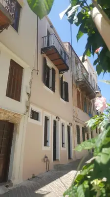 a building with a balcony on the side of it at Old Town Apartments in Chania Town