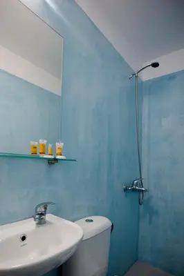 a bathroom with a sink and a toilet and a mirror at Kissamia - Self Check In Only - Next to Night Clubs in Kissamos