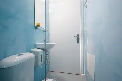 a bathroom with a toilet and a sink and a shower at Kissamia - Self Check In Only - Next to Night Clubs in Kissamos